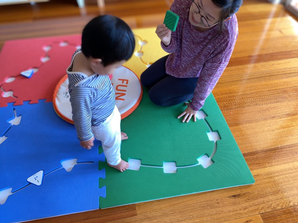Founder Mandy Lau is playing Reach and Match with her son Oliver at home. 